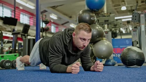 Muscular Man Training With Dynamic Push-Ups at Gym