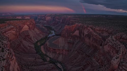 A Breathtaking Aerial View of a Wonderful and Gorgeous Canyon Showcasing a River During Sunset