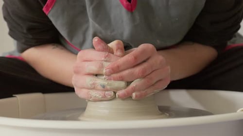 Hands Shaping Clay on Pottery Wheel, Close Up