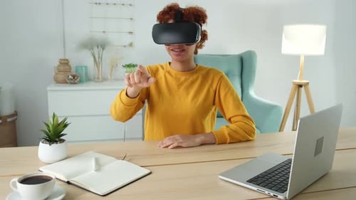 Woman Uses VR Headset At Table At Home