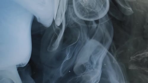 Wispy Plumes of Blue Emanate in Dark Space