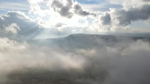Aerial View of Mountains Emerging from Clouds