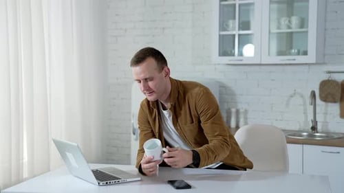 Young Man on Video Call in Bright Kitchen