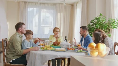 Waist Up Portrait View of the Multi Generation Family Sitting at the Dining Table During Festive