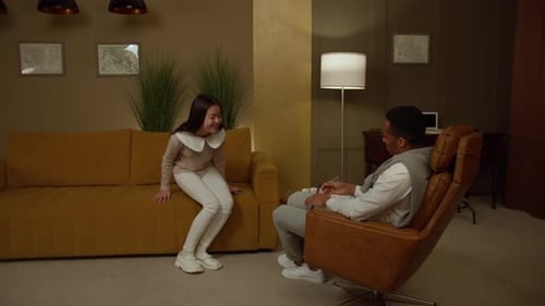 Girl Talking with Therapist in Warmly Lit Room