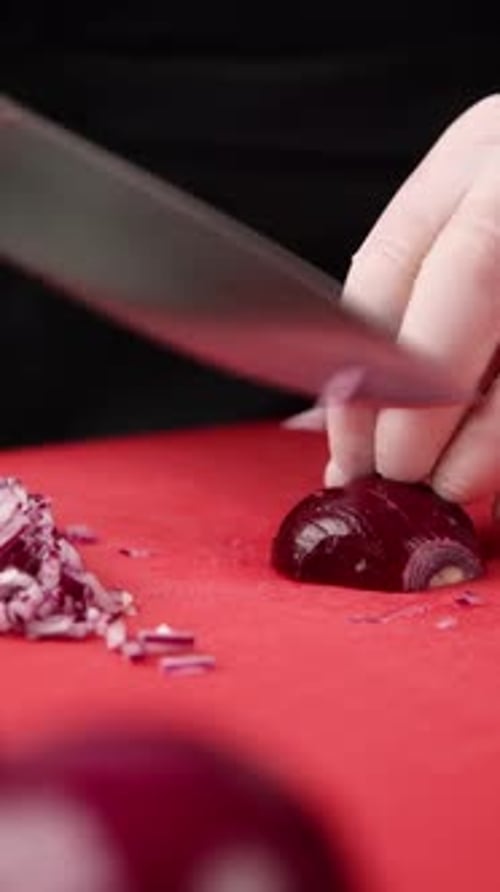 Slicing Fresh Red Onion on Cutting Board