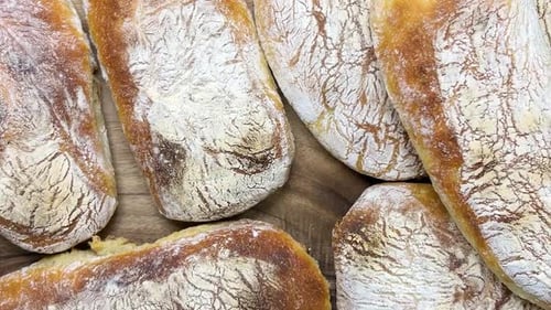 Fresh Baked Ciabatta Breads on Wooden Cutting Board