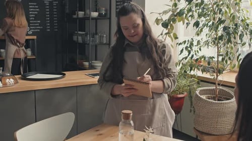 Waitress With Disability At Work In Cafe