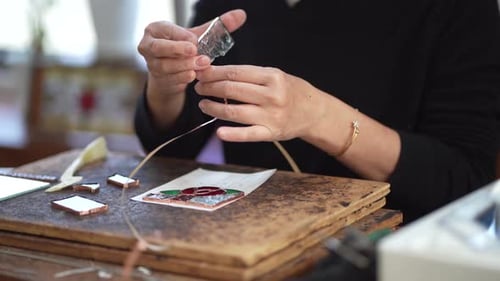 Craftsperson Assembling Stained Glass with Copper Foil Tape