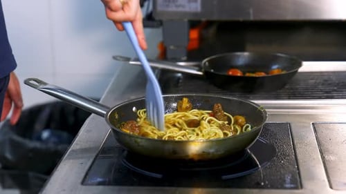 Chef Cooking Noodles in a Frying Pan
