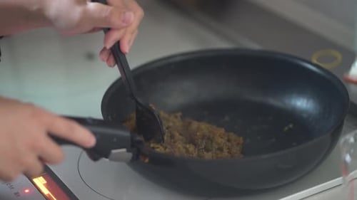 A woman making plum jam