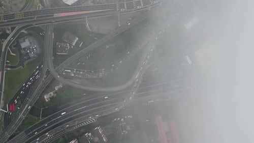 Aerial view of unique and atmospheric city under morning's low cloud cover