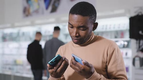 African Man in Electronics and Gadgets Department