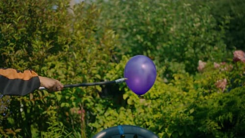 Balloon Pop with Orange Powder in Garden