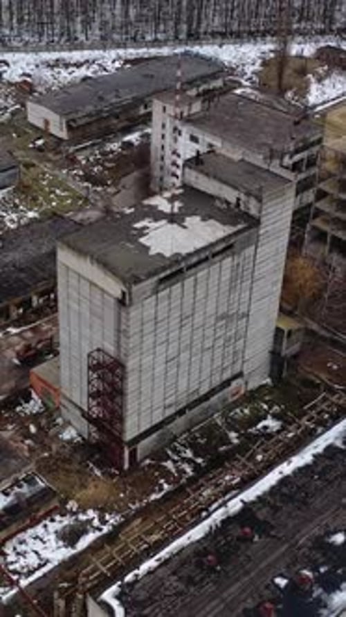 Ruined factory in winter time. Abolished buildings of industry.