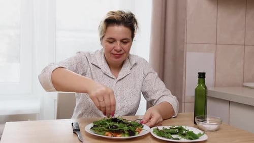 74. Woman preparing salad from vegetables and herbs. Preparing dishes from fresh vegetables.