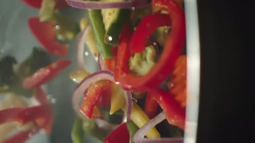 Closeup of Chef Preparing and Throwing Vegetable Mix on Frying Pan Preparation Fresh Appetizing Food