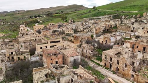 Exploring Abandoned Village: Aerial View of Scenic Ruins Amidst Green Hills