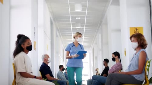 Nurse with patients in a clinic waiting room