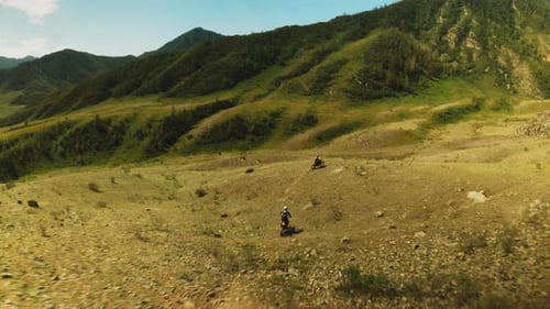 Motocross Race Against Landscape of Highlands
