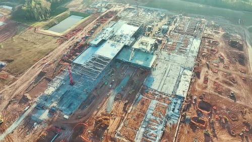 Vue aérienne du site de construction avec assemblage d'une grande structure d'usine moderne pour la production et
