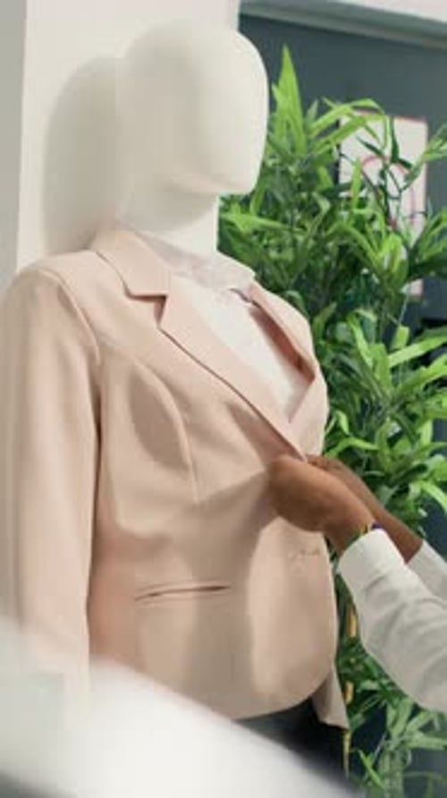 Vertical Video Woman Arranging Mannequin in SH Shop