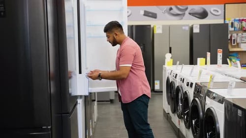 Indian Man Chooses a Fridge in Tech Store on Black Friday