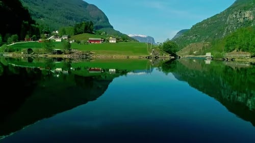 Drone Shot of Amazing Coastline of Norway, Flam Village, Fjord and Green Hills Reflections on Water