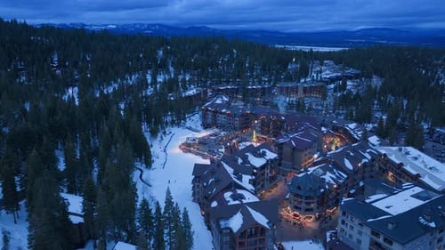 Evening Snowfall Over Mountain Resort Village at Palisades Tahoe California USA