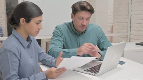 Multi Ethnic Business People Doing Paperwork in Office