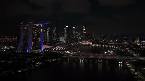 Fly sideways towards Singapore Flyer, view of Marina Bay Sands and more