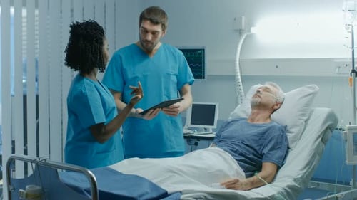 In the Hospital, Senior Man Lying in the Bed, Talks with Doctor and Nurse who Diagnose Him Using Ta