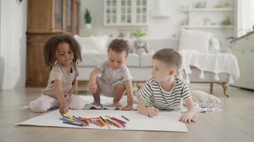 Three Children Drawing with Colored Pencils at Home