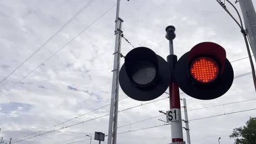 Red Traffic Light Signals on Cloudy Day Under the Vast Sky