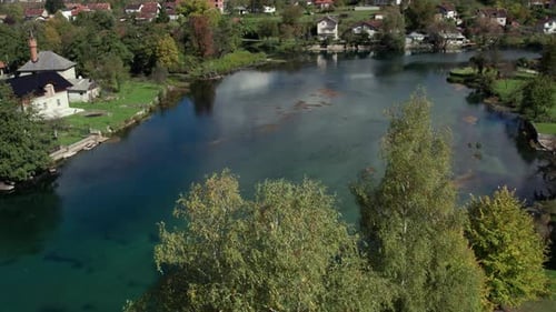 Aerial drone view of Una River and riverside houses near Bihac Bosnia and Herzegovina