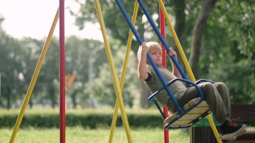 Boy Swinging on Swing in Park Child Having Fun Playing on Outdoor Public Playground Kids Play on