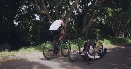 Men Cycling Together on Urban Road