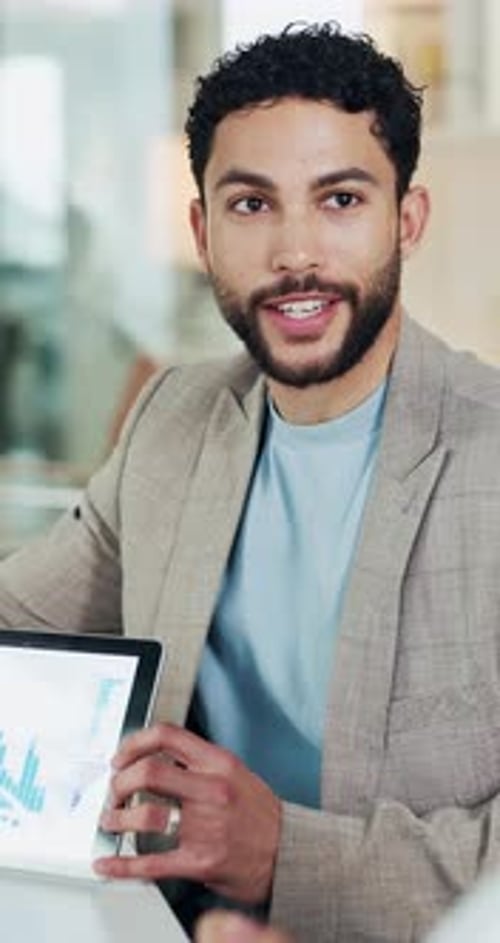 Business, man and meeting with graphs on tablet for accounting, data analysis and annual report
