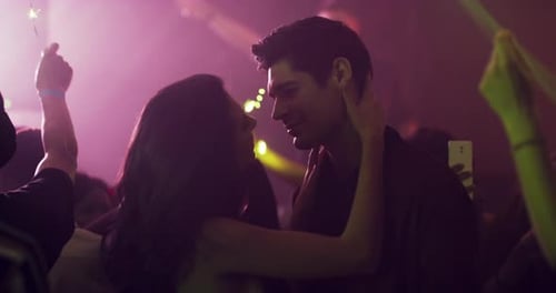 4k video footage of an affectionate young couple dancing together at a party in a nightclub