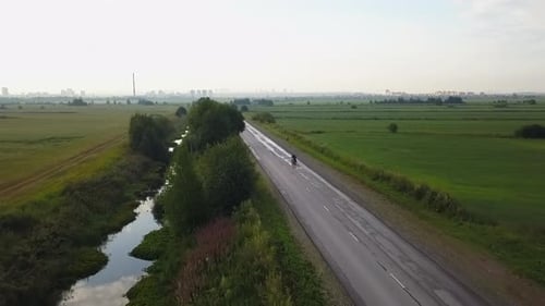 Aerial View of Motorcyclist Riding on Country Road Clip
