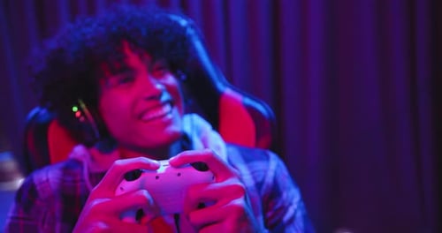 Excited Young Gamer Playing Video Game at Night