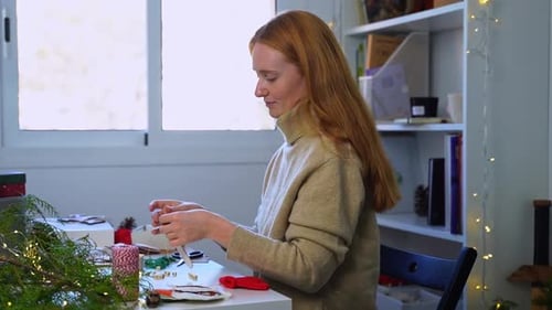 Closeup Redhaired Woman Hands Creating Christmas Decoration for New Year Tree
