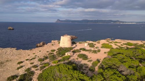 mediterranean coastal sunset ancient historic tower. Beautiful aerial top view flight ascending dron