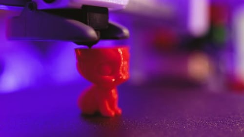 3D Printer Creating Red Figure