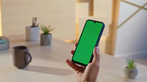 Worker Checking Greenscreen Smartphone in Office Space Closeup Handsome Man