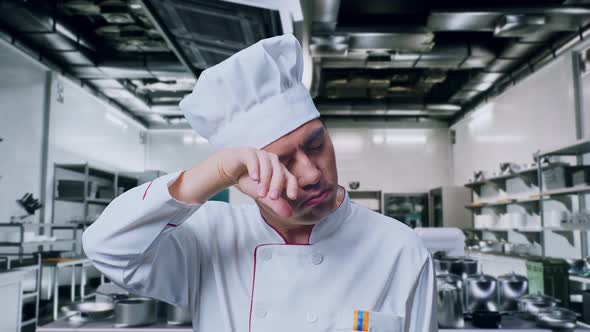 Close Up Of Asian Man Chef Wiping The Sweat Being Tired Cooking In ...