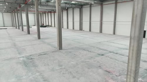 Drone Footage of Modern Storage Interior Empty Industrial Space with Concrete Floor Warehouse Inside