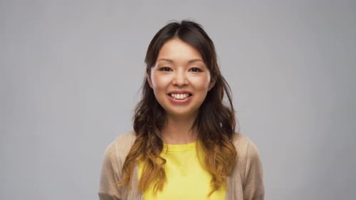 Smiling Young Woman in Yellow Shirt Close Up
