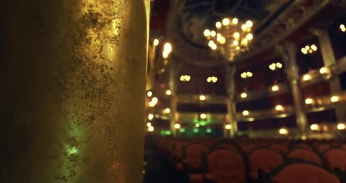 Elegant Interior of a Historic Theater with Ornate Lighting and Seating