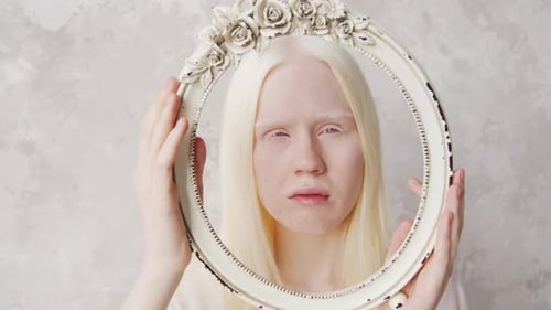 Person Poses with Decorative Oval Frame